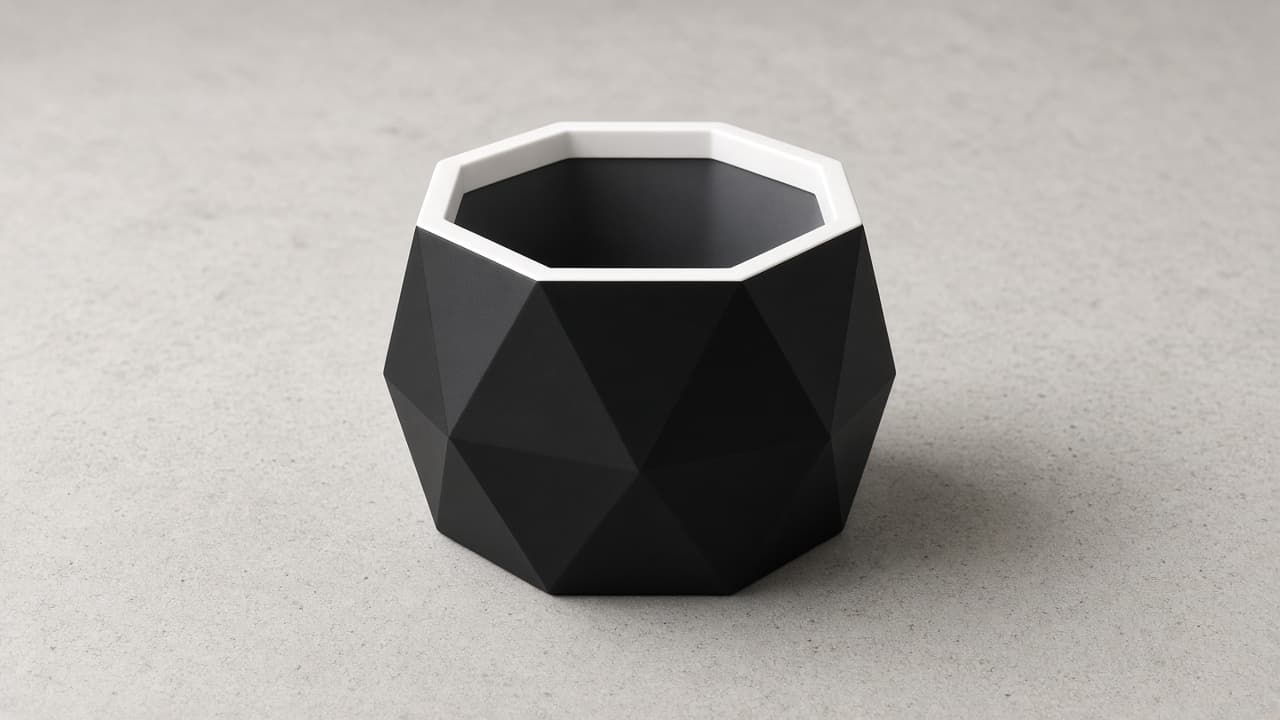Black geometric planter with white interior rim